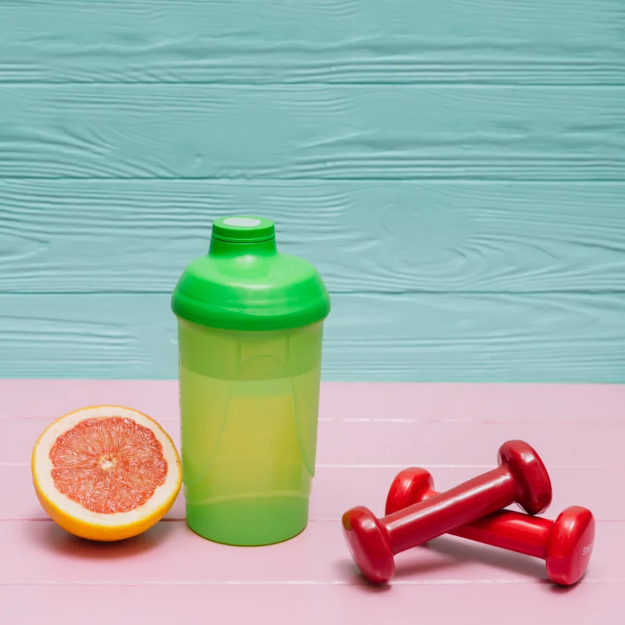 A water bottle, towel and small dumbbells laid out flat, representing the fitness and wellness category