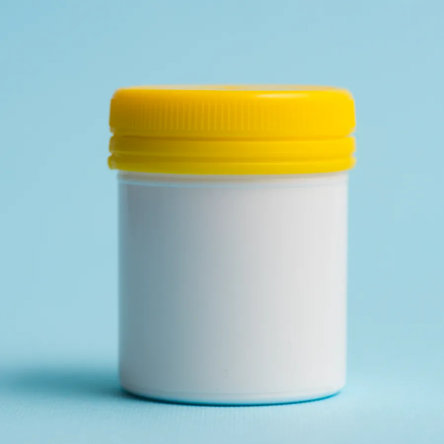 A white supplement bottle with capsules spilling out, representing the supplements category